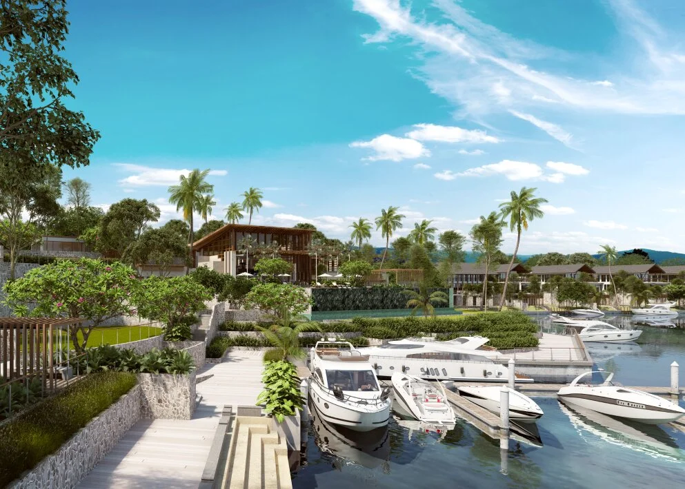 Marina clubhouse with infinity-edge pool overlooking the private canal at Emerald Bay, boats docked alongside